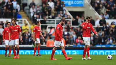 Aron Gunnarsson, centre, and Jordon Mutch, right, of Cardiff City look dejected during the Premier League match against Newcastle United at St James' Park on May 3, 2014. Matthew Lewis / Getty Images