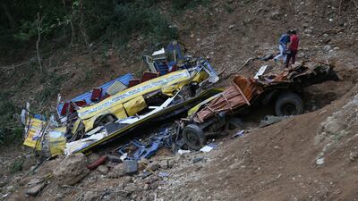 A school bus lies at the bottom of a gorge in Kangra district, Himachal Pradesh. EPA