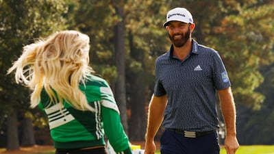 Dustin Johnson celebrates with partner Paulina Gretzky on the 18th green after winning The Masters. Reuters