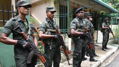 Sri Lankan army soldiers stands guard on a roadside during special cordon-and-search operations in Colombo on May 25, 2019. AFP