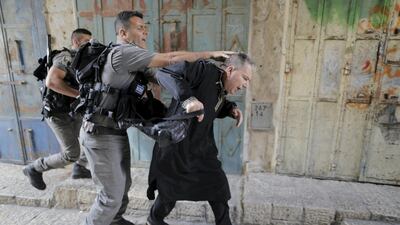 Israeli border police officers detain a Palestinian protester in Jerusalem's Old City. Ammar Awad / Reuters