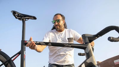 Omar Nour holds up the Ventum NS1, which costs between Dh13,000 and Dh50,000 depending on the model. The Ventum One triathlon model can cost Dh60,000