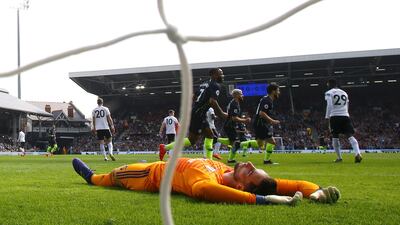 Sergio Rico of Fulham reacts as Bernardo Silva of Manchester City celebrates with teammates after scoring his team's first goal. Getty Images