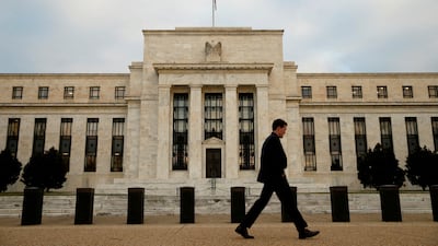 A man walks past the US Federal Reserve building in Washington. Reuters