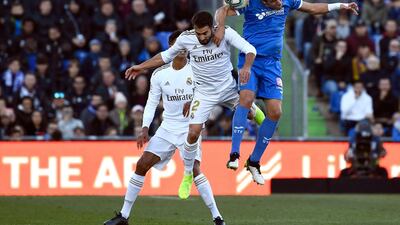 Real Madrid defender Dani Carvajal vies for the ball with Getafe's Jaime Mata on Saturday. AFP