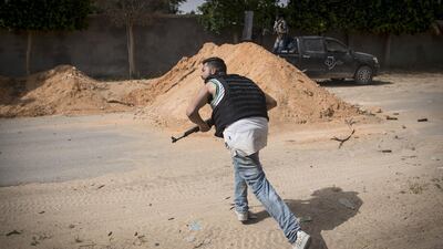 A fighter loyal to the internationally recognised Government of National Accord runs for cover during clashes with forces loyal to Khalifa Haftar south of the capital Tripoli. AFP