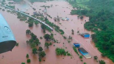This handout photo provided by the Indian Navy shows the Mahalaxmi Express train marooned in floodwaters in Badlapur, in the western Indian state of Maharashtra, Saturday, July 27, 2019. Rescuers in India have evacuated more than 500 passengers from the train after it got stuck in floodwaters triggered by heavy rains between two stations near Mumbai. (Indian Navy via AP)
