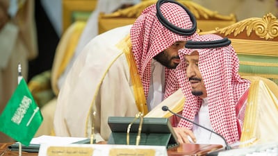 King Salman speaks with Crown Prince Mohammed during the conference. EPA