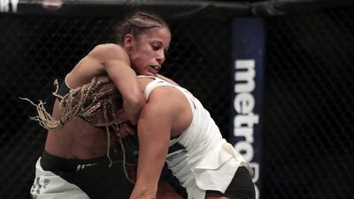 Liz Carmouche, left, grabs at Katlyn Chookagian during a women’s bantamweight mixed martial arts bout. Julio Cortez / AP Photo