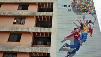 An Indian man looks out of his window on 'International Day against Drug Abuse and Illicit Trafficking' in Mumbai, India. Rafiq Maqbool / AP Photo