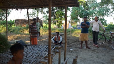 Pappu Kumar Soren, whose father was killed by a snake, and his neighbours discuss the increasing numbers of snakes within the village of Singhia