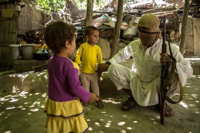Qary Khalid, 25, greets his children in the courtyard of his house. Stefanie Glinski for The National