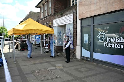 Police officers outside the former office of the Jewish Futures charity. AFP