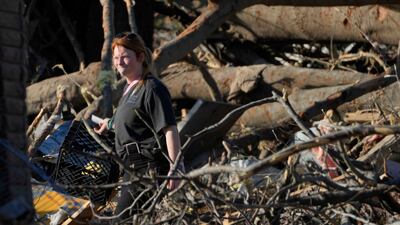 A Rolling Fork resident tries to salvage personal items after the tornado. AP