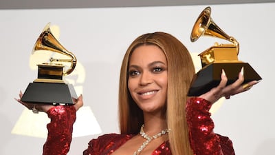 Beyonce poses with her trophies won during the 59th annual Grammy Awards in 2017. AFP / Robyn Beck