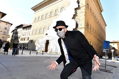 French contemporary artist JR poses in front of his art installation on the facade of Strozzi Palace. Reuters