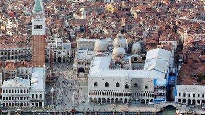 St Mark's Campanile stands over St Mark's Square in Venice, Italy. The Domes of the Basilica can be seen above Doges Palace at bottom right. Getty Images