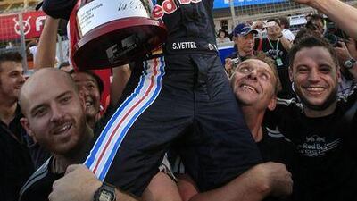 Red Bull driver Sebastian Vettel of Germany celebrates with his team after winning the Japanese Grand Prix at Suzuka. The result keeps the German in contention for the world title with two races left of the season.