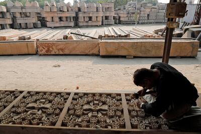A worker engraves a stone that Hindu groups say will be used to build a temple at a disputed religious site in Ayodhya. Reuters
