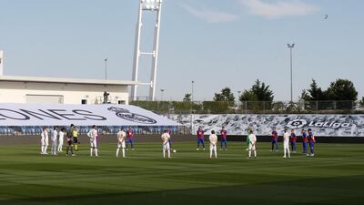 Real Madrid and Eibar players observe a minute of silence in honor of victims of the coronavirus pandemic ahead of the game. EPA