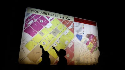 Pilgrims check a map ahead of the Haj main ritual at Mount Arafat. Hassan Ammar / AP Photo