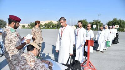 National service recruits queue to report for training. WAM