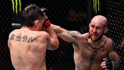 Brian Kelleher, right, punches Ricky Simon in their featherweight fight during the UFC 258 event at UFC APEX in Las Vegas, Nevada. Jeff Bottari / Zuffa LLC / UFC
