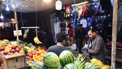 A man talks to a fruit vendor at a market in the southern Iraqi city of Nasiriyah in the Dhi Qar province. AFP