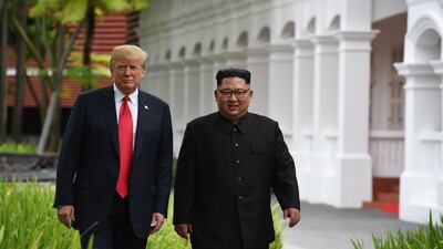 North Korea's leader Kim Jong-un walks with US President Donald Trump during a break in talks. Anthony Wallace / AFP