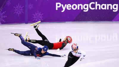 Jinyu Li of China and Elise Christie of Great Britain fall after contact as Minjeong Choi of Korea skates past during the Short Track Speed Skating Ladies' 1,500m Semifinals at the PyeongChang 2018 Winter Olympic Games at Gangneung Ice Arena. Dean Mouhtaropoulos / Getty Images