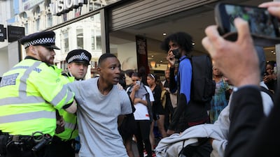 Police officers detain a person. Reuters