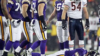 Chicago's Brian Urlacher, #54, looks down at the injured Brett Favre on Monday.