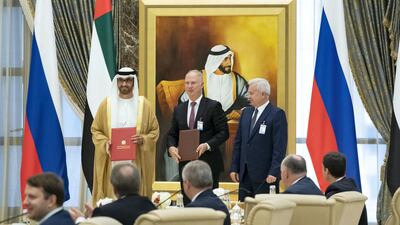 Dr Sultan Al Jaber, CEO of Adnoc Group, left, exchanges an MOU with Kirill A Dmitriev, CEO of the Russian Direct Investment Fund (RDIF), centre, and Vagit Alekperov, president of Lukoil. Hamad Al Mansoori for the Ministry of Presidential Affairs