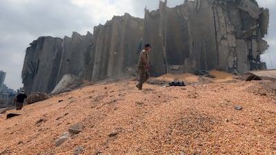 Lebanese army members walk near the damaged grain silo at the site of Tuesday's blast, at Beirut's port area, Lebanon, August 7, 2020. REUTERS