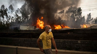 A burning warehouse during a wildfire in Agueda, Portugal. Vast blazes blamed on climate change have hit the country in recent years, killing hundreds of people. AFP