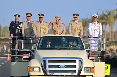 Mr El Sisi salutes on his way to the opening ceremony. EPA