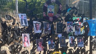 Pictures of those killed in the strike on the football pitch in Majdal Shams on Saturday, Mourners have added black ribbons to the site. Thomas Helm / The National