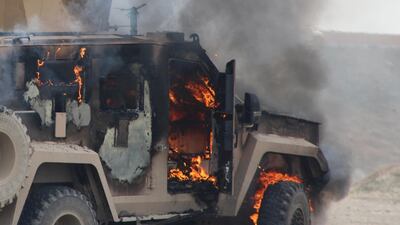 A military vehicle at the scene of an ISIS suicide car bomb attack on a US-Kurdish military convoy in Syria's northeastern Hasakeh province, which killed five people / AFP