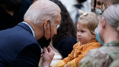 US President Joe Biden greets a young child during a visit to Fort Bragg to mark the upcoming Thanksgiving holiday on Monday. AP Photo