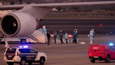 Evacuated passengers prepare to board a plane bound for US at the Tenerife Sur-Reina Sofia airport. AFP