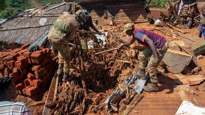 Soldiers help residents retrieve their lost belongings in Chimanimani. AFP
