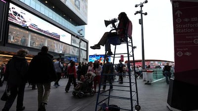 A volunteer 'Games Maker' directs Olympic Park visitors. Pic: Carl Court/AFP
