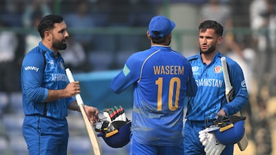 Mohammad Nabi and Azmatullah Omarzai of Afghanistan are congratulated by UAE skipper Muhammad Waseem. Getty Images