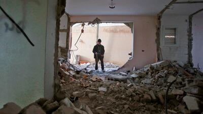 The father of Arafat Irfaiya, a 29-year-old Palestinian accused of killing a young Israeli woman last February stands inside the damaged family home after Israeli army buldoser destroyed it in the Israeli-occupied West Bank town of Hebron, on April 19, 2019. AFP