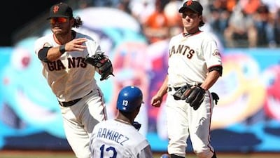 Los Angeles' Hanley Ramirez slides for the plate as Brandon Crawford of the Giants turns a double play.