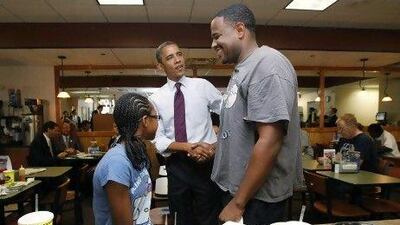 US president Barack Obama greets diners during a campaign stop at a Cincinnati restaurant. In 2008 he secured 95 per cent of the black vote and made history.