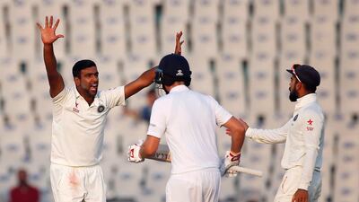 Ravichandran Ashwin, left, again India's dangerman, claiming three of four England wickets on Day 3 in Mohali. Adnan Abidi / Reuters
