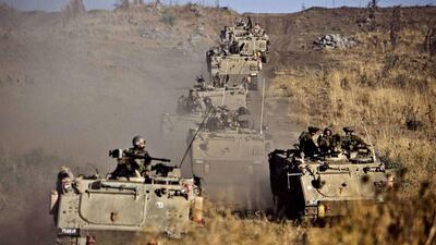 Israeli army Armored Personnel Carriers maneuver during a military exercise in the Israeli-annexed Golan Heights near the northern border with Syria. Jack Guez / AFP
