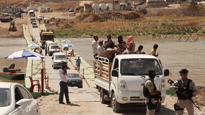 The Fish-Khabur crossing between Iraqi Kurdistan and Turkey, which was taken over by Baghdad on October 31, 2017. Here, displaced people from the minority Yazidi sect, fleeing the violence in the Iraqi town of Sinjar, re-enter Iraq from Syria via the crossing on August 13, 2014. Ari Jalal / Reuters
