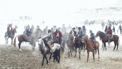 A scrum of horses and riders collide into each other as they each fight for the calf carcass.